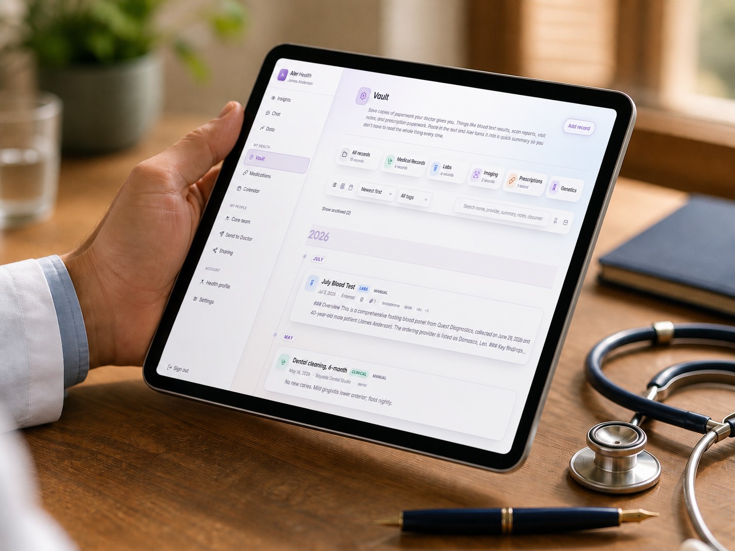 A hand holding a tablet showing medical charts, beside a stethoscope.